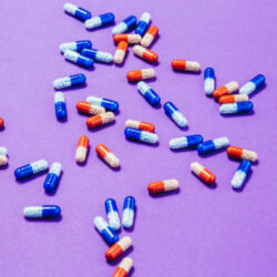 Pills on purple background.